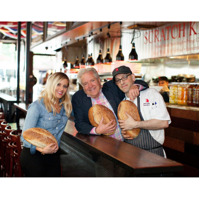 Missy Claridge, Tim Firnstahl, and Jason Amador holding sourdough loaves at Von’s 1000Spirits new Seattle location, 1225 1st Avenue