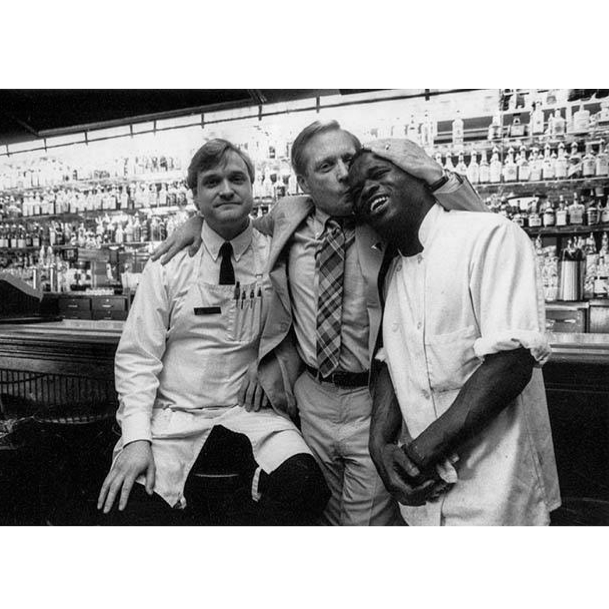 Tim Firnstahl sharing a candid moment with kitchen team members behind the bar in the early days of Von’s 1000Spirits